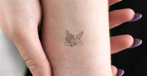 Sleeping Cherub Temporary Tattoo Located On The Wrist