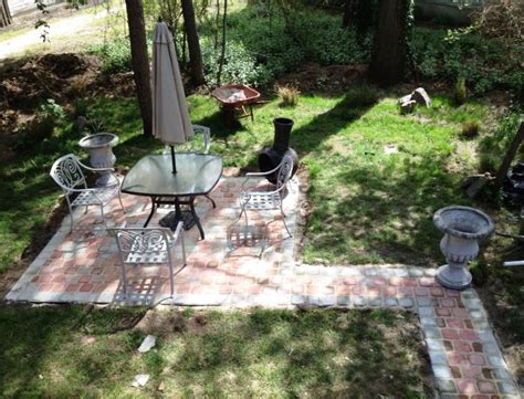 A Patio With Chairs Tables And An Umbrella In The Middle Of It