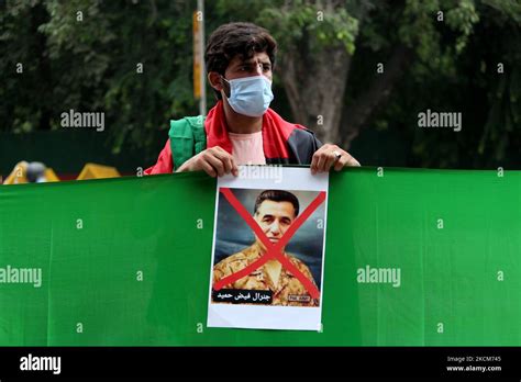 An Afghan National Residing In India Holds A Poster Of Isi Chief Faiz