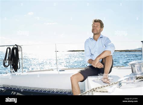 Mature Man Sitting On His Sailing Boat Stock Photo Alamy
