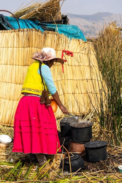 Mulher Peruana Em Roupas Tradicionais Cozinha Comida Na Ilha Flutuante