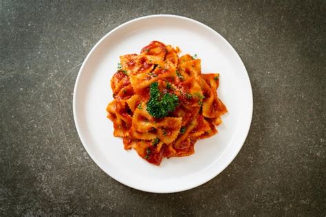 Premium Photo | Farfalle pasta in tomato sauce with parsley