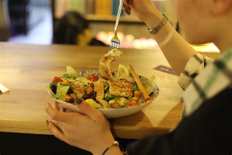 A Person Eating a Salad on a Plate · Free Stock Photo