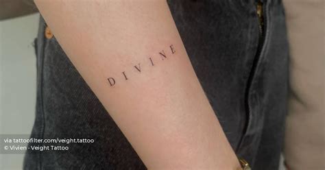 Word Divine Tattooed On The Forearm