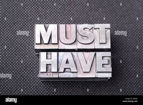 Must Have Phrase Made From Metallic Letterpress Blocks On Black