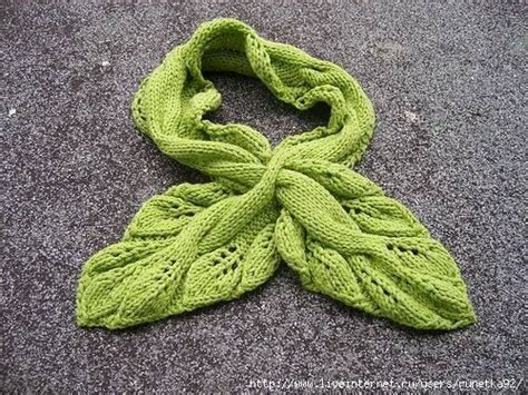 A Green Knitted Scarf Laying On The Ground