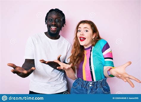 Interracial Couple Wearing Casual Clothes Smiling Cheerful With Open