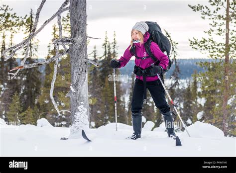 Young woman skiing with a backpack in Lapland Stock Photo - Alamy