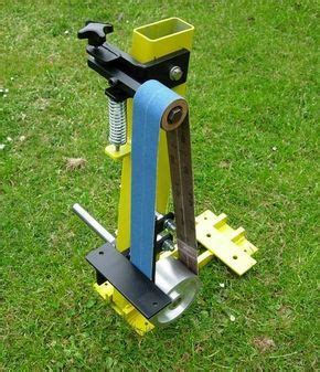 a machine that is on some grass in the day time and ready to use it
