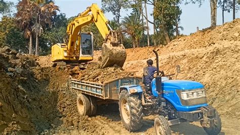 Jcb Dx Backhoe Loading Black Mud In Sonalika Di Rx Tractor