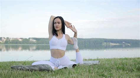 A Slender Beautiful Brunette Does Stretches During Yoga Classes Against Stock Footage Video Of