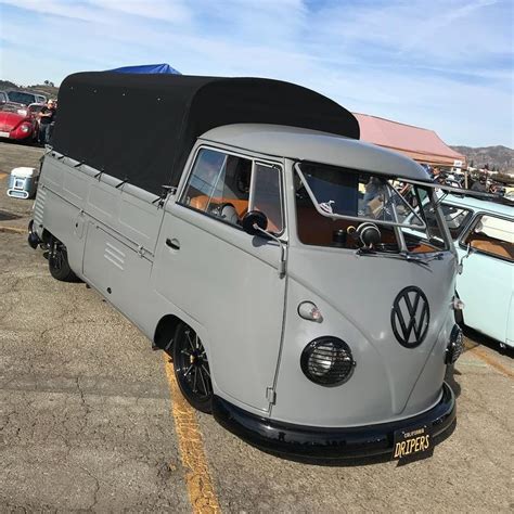 An Old Vw Bus Parked In A Parking Lot