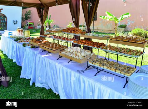 dessert buffet line on white tables in the garden Stock Photo - Alamy