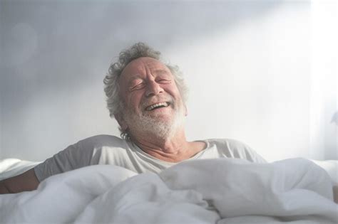 Premium Ai Image Elderly Man Happily Wakes Up In White Bedroom In