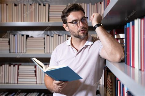 Premium Photo | Middle aged teacher in school library reading book ...