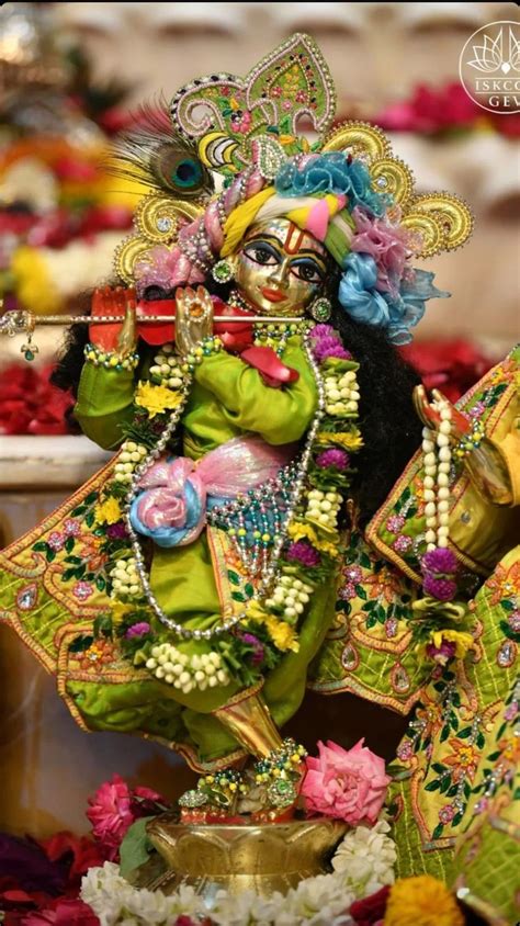 An Idol Is Displayed In Front Of Flowers