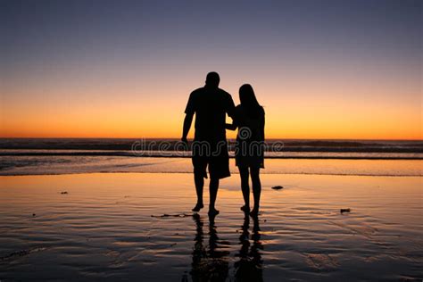 Silhouette of Couple Walking in Sunset Stock Image - Image of standing ...