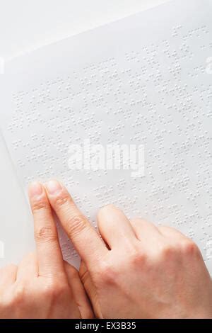 Hands Of A Blind Person Reading Some Braille Text Touching The Relief