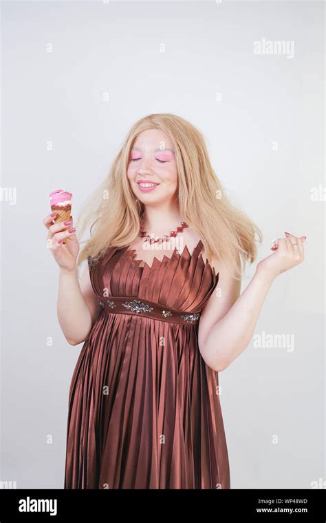 Cute Fashion Lady With Asian Face And Blonde Hair Enjoys Ice Cream