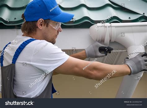 Installer Installs New Gutter Under Metal Stock Photo 2219502797 ...