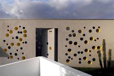 This Home Welcomes Visitors With An Entrance Featuring Colorful Holes