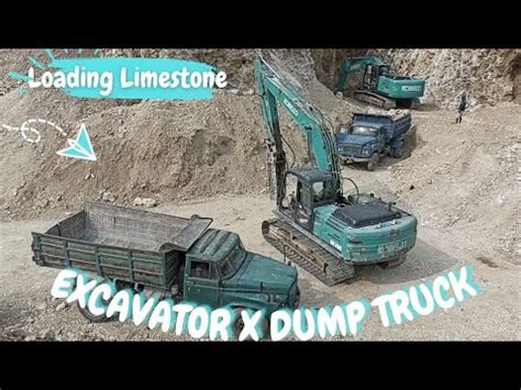 Excavator Kobelco Sk Loading Limestone Into The Dump Truck Youtube