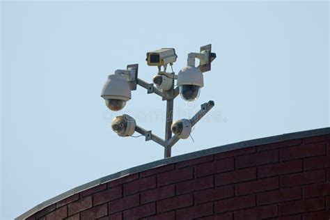 Many Modern Surveillance Cameras Mounted On A Building Roof Stock Image