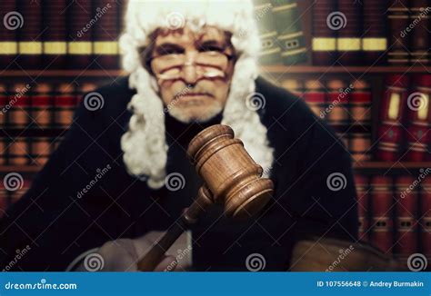 Male Judge In A Courtroom Striking The Gavel Stock Photo Image Of