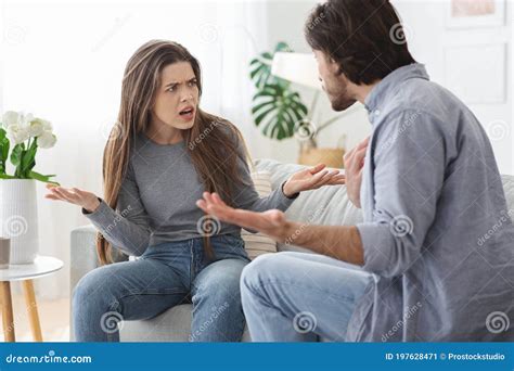 Angry Married Couple Fighting Yelling At Each Other At Home Stock