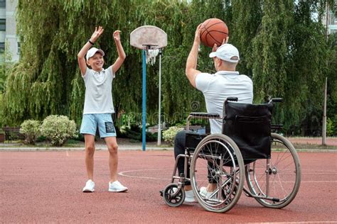 Dad Plays With His Disabled Son On The Sports Ground Concept