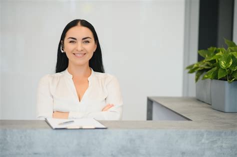 Premium Photo Portrait Of Beautiful Receptionist Near Counter In Hotel