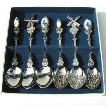 Six Silver Spoons In A Box With Crosses On The Top And One Is Empty