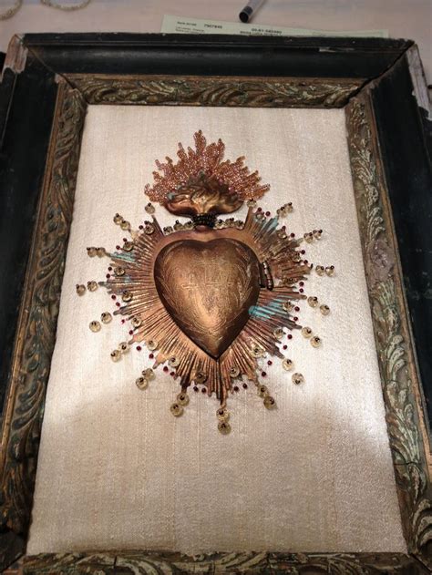 An Ornate Framed Painting With A Heart On It