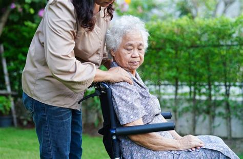 Caregiver Help Asian Elderly Woman Disability Patient Sitting On