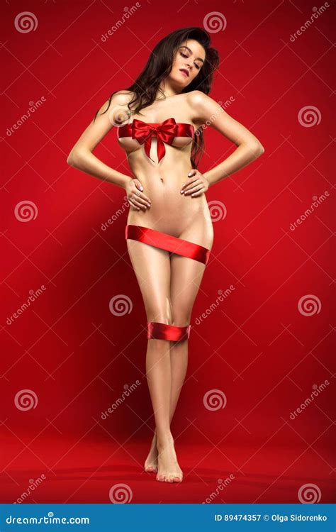 Beautiful Naked Woman Wrapped With Red Gift Ribbon Posing Isolated On