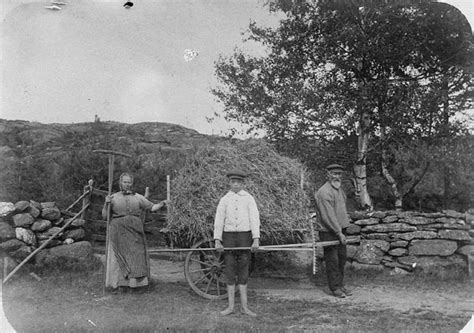 An Old Black And White Photo Of Three People Standing In Front Of A