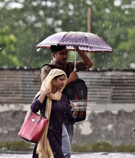 People Caught In A Sudden Heavy Rainfall And Dust Storm At Mg Road