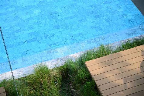 Wooden Veranda and Blue Swimming Pool Stock Image - Image of house, luxury: 272327423