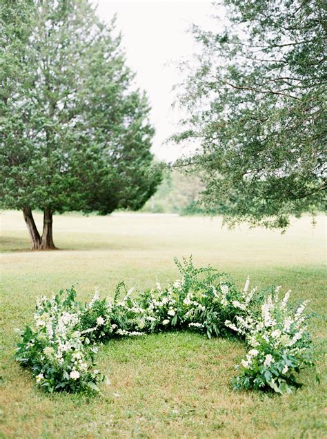 A Wedding Ceremony Trend We're Loving: Grounded Floral Arches | Wedding ...