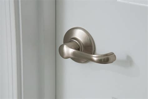 Premium Photo | Modern silver door handle on white door