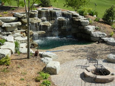 Backyard waterfall, beach & patio with fire pit, this would be awesome ...