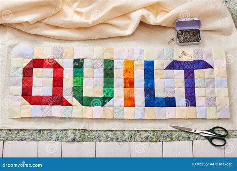 The Word Quilt Sewn From Colorful Square And Triangle Pieces Of Fabric