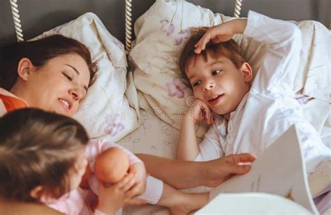 Mother Reading Book To Her Sons In The Bed Stock Image Image Of