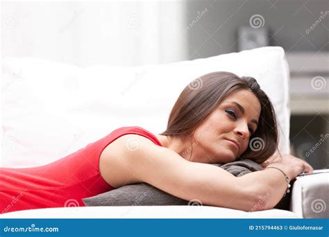 Young Woman Lying On Her Stomach Relaxing On A Sofa Stock Image Image