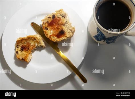 Toasted Hot Cross Bun With Jam And Black Coffee Stock Photo Alamy