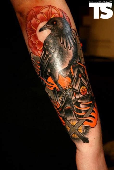 Old school colorful forearm tattoo of crow with burning city ...