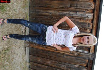 Pretty Blonde Chick Posing In Jeans And Shirt Outdoors Photos