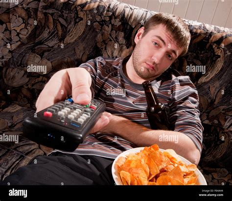 sleepy man  beer  chips watching tv  home stock photo alamy