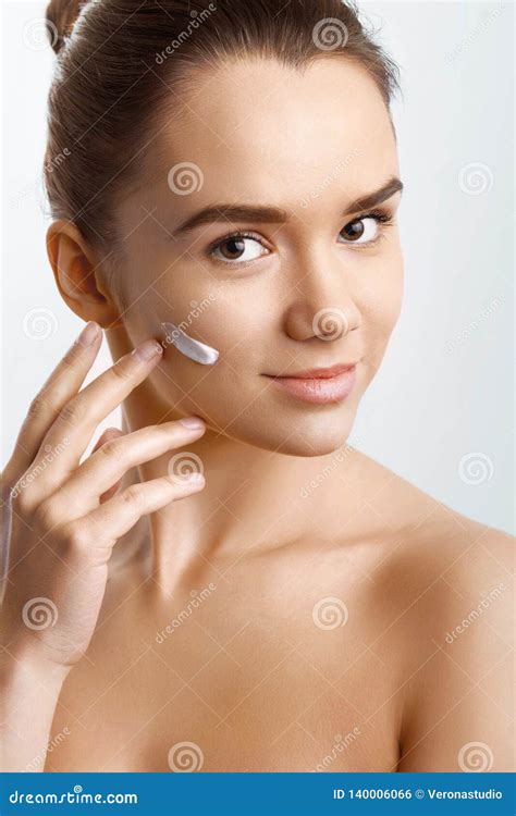 Beautiful Model Applying Cosmetic Cream On Her Face Beauty Skin Care