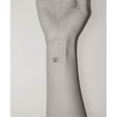 Minimalistic Style Peace Heart Tattoo Done On The